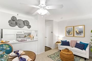 Metairie apartment for rent - A living room with a white couch and a ceiling fan.