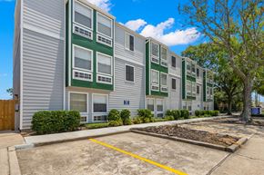 Metairie apartment for rent - Apartment building with a parking lot in front.