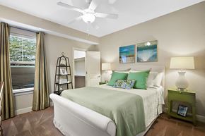 Metairie apartment for rent - A bedroom with a large bed and a ceiling fan.