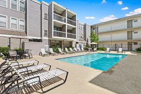 Metairie apartment for rent - A pool area with sun loungers and a swimming pool.