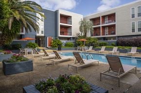 Metairie apartment for rent - A pool area with lounge chairs and a small pool.