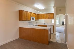 Fresno apartment for rent - A kitchen with white countertops and wooden cabinets.