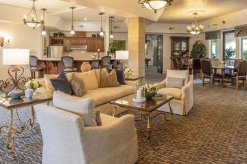 Fresno apartment for rent - A living room with a variety of furniture including a sofa, armchairs, and a coffee table.