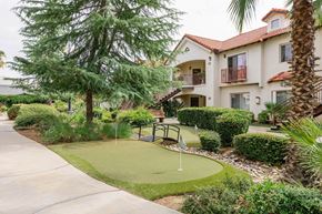 Fresno apartment for rent - A small putting green in front of a building.