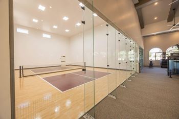 A squash court with glass door