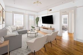 El Paso apartment for rent - A living room with a grey couch, a white chair, and a black television.