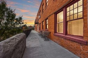 El Paso apartment for rent - A brick building with a bench on the sidewalk.