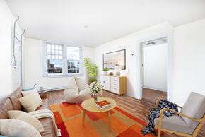 El Paso apartment for rent - A living room with a brown couch, a coffee table, and a chair.