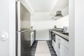 Denver apartment for rent - a renovated kitchen with white cabinets and stainless steel appliances