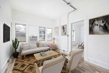 El Paso apartment for rent - A living room with a couch, a chair, a rug, and a painting on the wall.