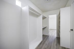 El Paso apartment for rent - an empty room with white closets and a wood floor