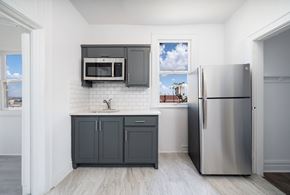 El Paso apartment for rent - A kitchen with a stainless steel refrigerator and a white tiled backsplash.