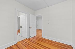 Denver apartment for rent - an empty room with wooden floors and white walls