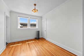 Denver apartment for rent - an empty living room with wood floors and a window