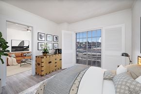 El Paso apartment for rent - A bedroom with a large bed and a view of the city.