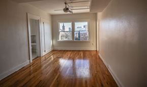 El Paso apartment for rent - A room with wooden floors and a ceiling fan.