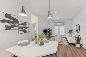 Cary apartment for rent - A modern dining room with a white table and chairs.