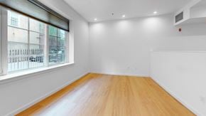 Philadelphia apartment for rent - A room with wooden flooring and a window overlooking a building.