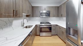 Philadelphia apartment for rent - A modern kitchen with a marble countertop and stainless steel appliances.