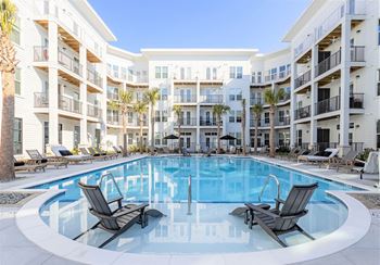 Resort-style pool with sunbathing deck