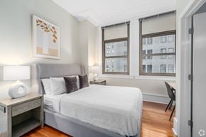 Nashville apartment for rent - A bedroom with a large bed and a chair.