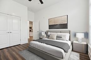 Cary apartment for rent - A bedroom with a large bed and a ceiling fan.