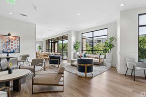 Cary apartment for rent - A living room with a large window and a painting on the wall.