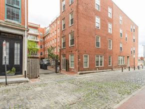 Philadelphia apartment for rent - A cobblestone street leads to a red brick building.