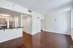 Philadelphia apartment for rent - A spacious room with wooden floors and white walls.