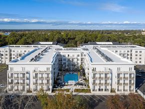 Charleston apartment for rent - A large white hotel with a pool in the middle of it.