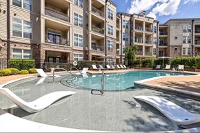 Cary apartment for rent - A swimming pool in front of apartment buildings.