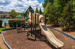 Cary apartment for rent - A playground with a slide and a climbing structure.