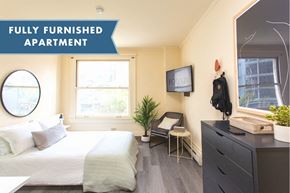 San Francisco apartment for rent - A fully furnished apartment with a bed, chair, and TV.