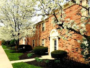 Columbus apartment for rent - a brick building with flowering trees in front of it
