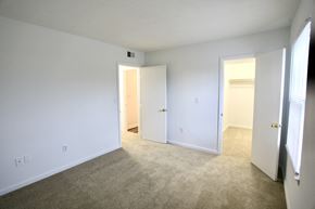 Indianapolis apartment for rent - a bedroom with white walls and carpet and a door to a closet