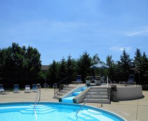 Columbus apartment for rent - a swimming pool and patio with chairs and an umbrella