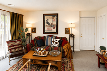 Indianapolis apartment for rent - A living room with a couch, chair, and a painting on the wall.