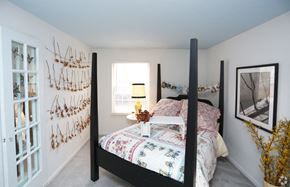 Indianapolis apartment for rent - a bedroom with a four poster bed and a window