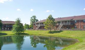 Indianapolis apartment for rent - a view of a building with a pond in front of it
