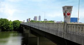 Indianapolis apartment for rent - a bridge over a river with a city in the background