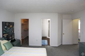 Indianapolis apartment for rent - a bedroom with a bed and a closet and a living room
