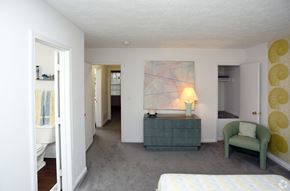 Indianapolis apartment for rent - a bedroom with a bed and a dresser and a chair in a room with