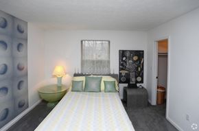 Indianapolis apartment for rent - a bedroom with a bed and a dresser and a window