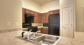 Scottdale apartment for rent - decatur affordable family apartment a kitchen with a sink and a black refrigerator