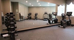 Clarkston apartment for rent - a gym with a mirrored wall with weights on it