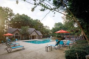 Decatur apartment for rent - a swimming pool with chairs and umbrellas in front of a house decatur luxury living
