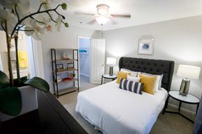 Decatur apartment for rent - a bedroom with a large white bed and a ceiling fan decatur luxury living
