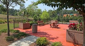 Atlanta apartment for rent - A park with a red surface and a black fence.