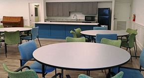 Stone Mountain apartment for rent - a dining room with tables and chairs and a kitchen with a sink