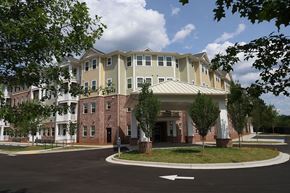 Clarkston apartment for rent - an apartment building with a roundabout in front of it